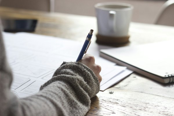 A student writing down study goals in a notebook